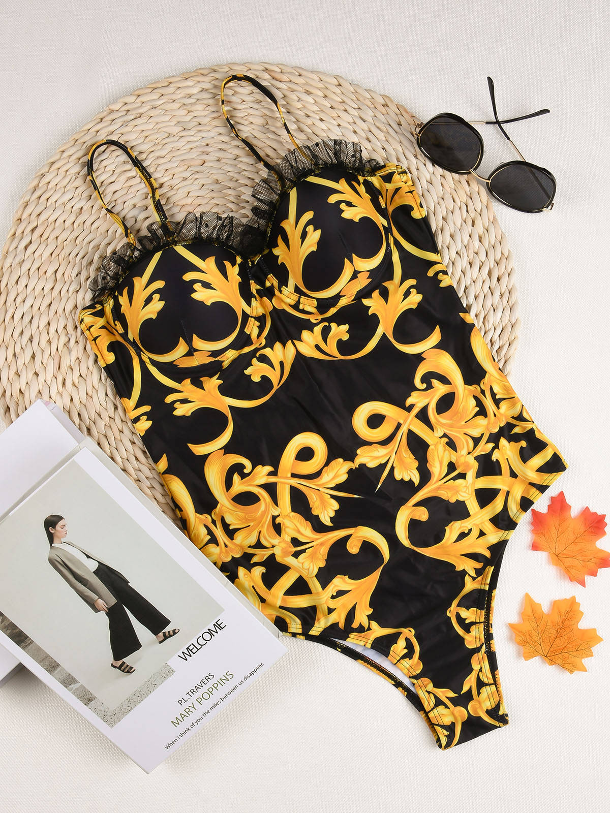 Black monokini with Brazilian gold print accents and cutout sides.