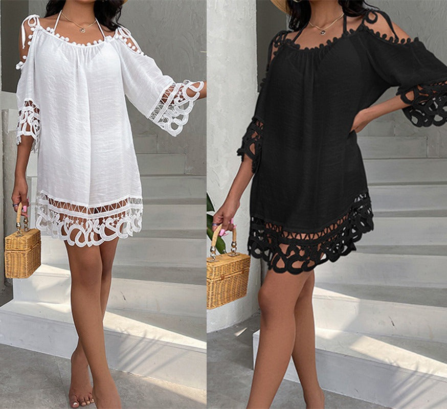 Off-shoulder dress swimsuit cover-up with lace details worn by a person against a white wall.