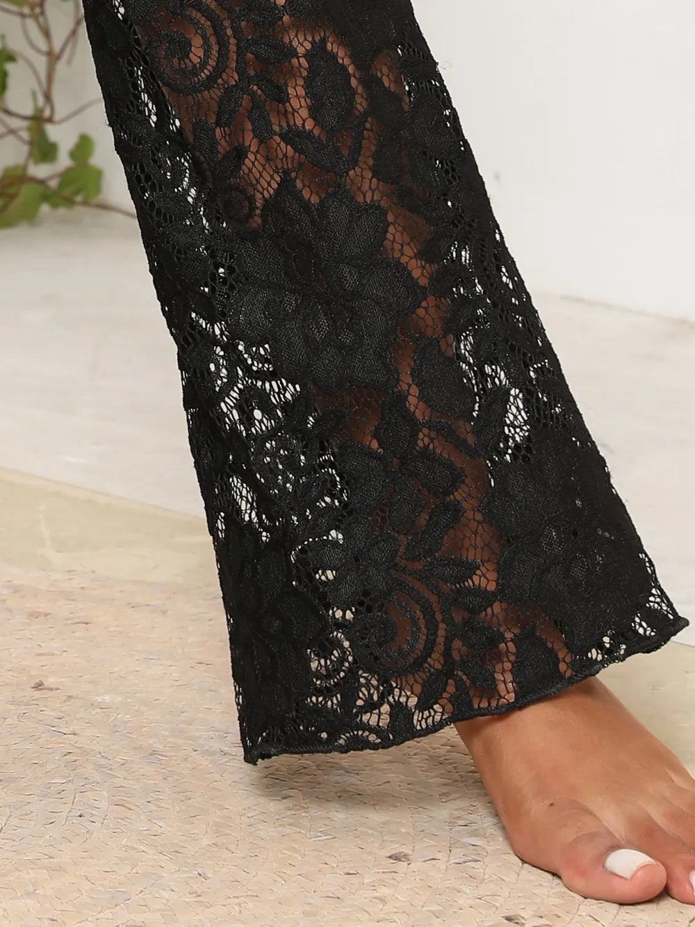 Close-up of delicate lace trim and fabric texture on swim pants cover up.