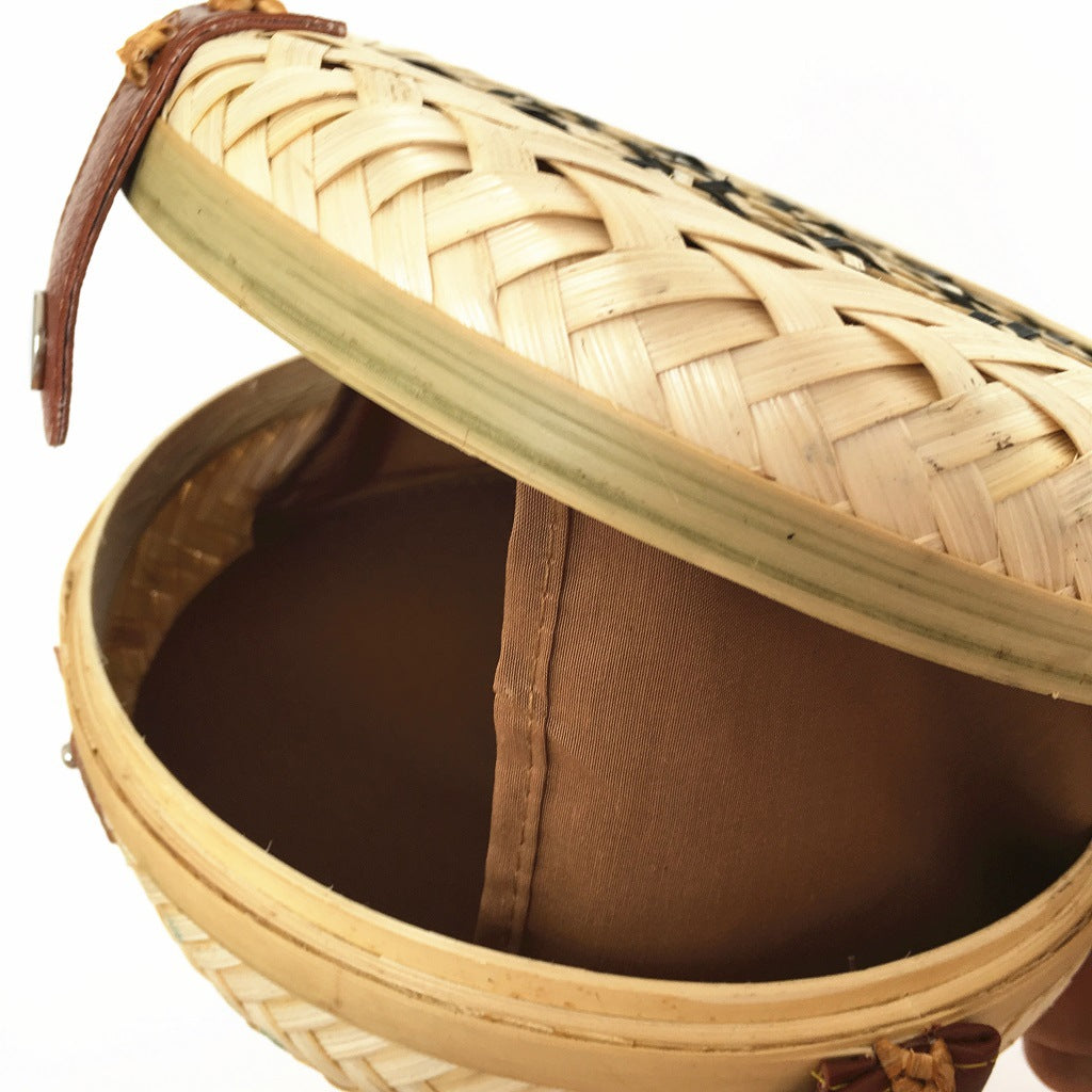 Woven basket with decorative lid on a white background