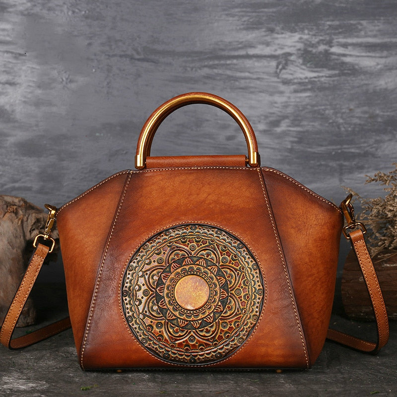 Tan genuine cow leather handbag with polished hardware.