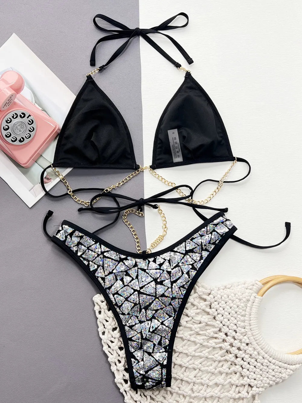 Black sequin halter‑neck two‑piece bikini set with geometric pattern, featuring a V‑neck sleeveless top and matching bikini bottoms.