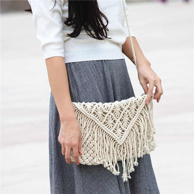 Person wearing a gray skirt with a woven bag on a white background