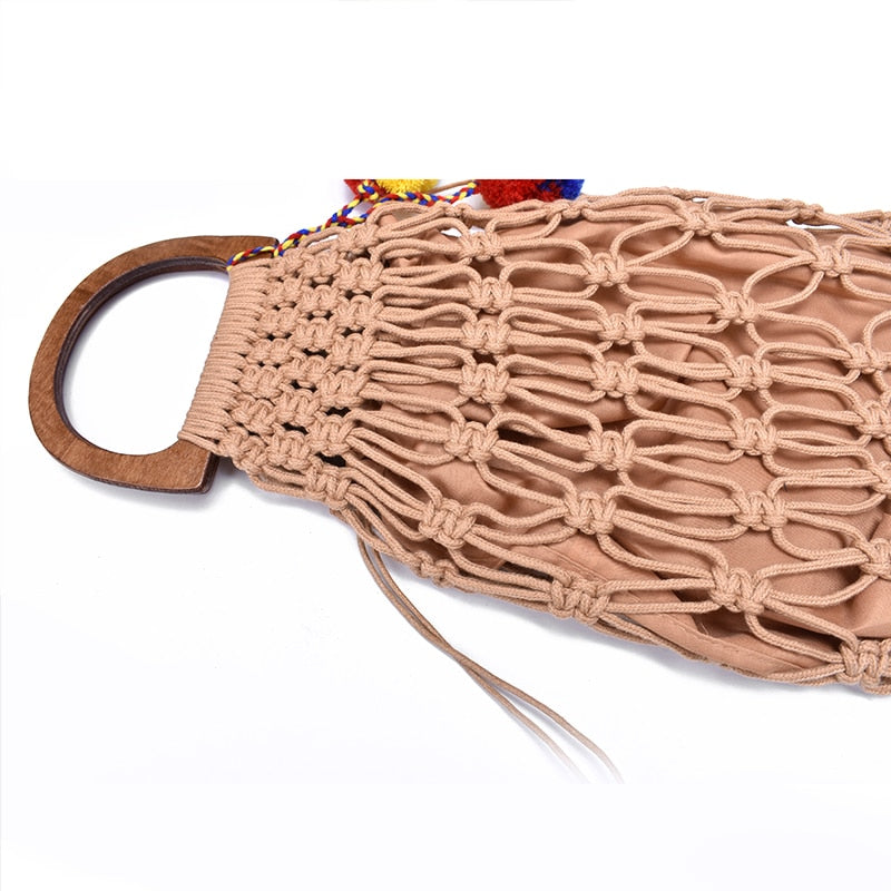Brown woven handbag with wooden handles.