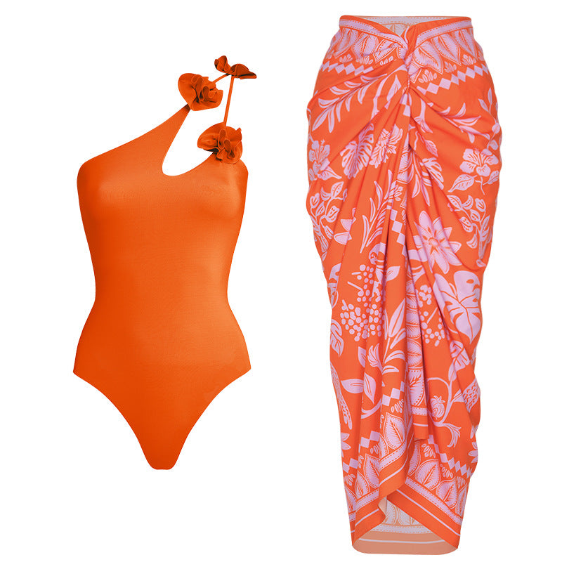 Orange swimsuit with floral details on a neutral background