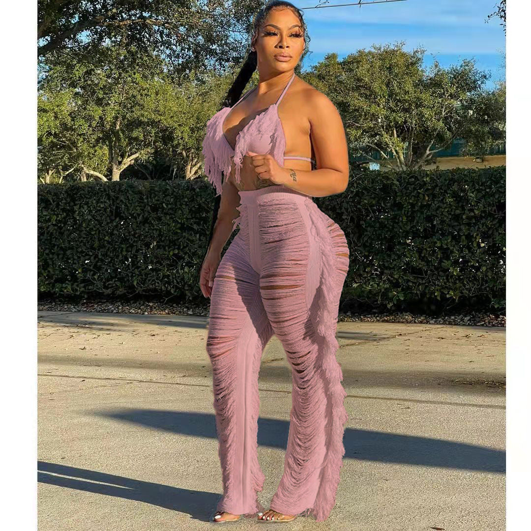 Woman wearing a pink outfit standing outdoors with trees in the background