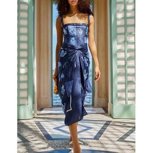 Woman wearing a blue floral dress in an elegant interior setting sold at PeachyBeanz.