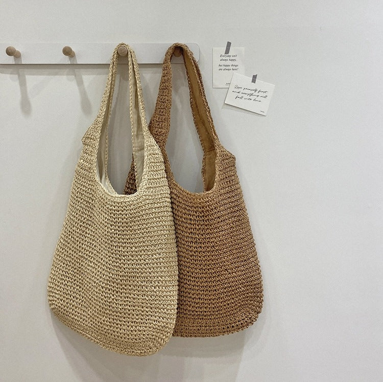 Two woven bags hanging on a hook against a white wall. Sold at PeachyBeanz.