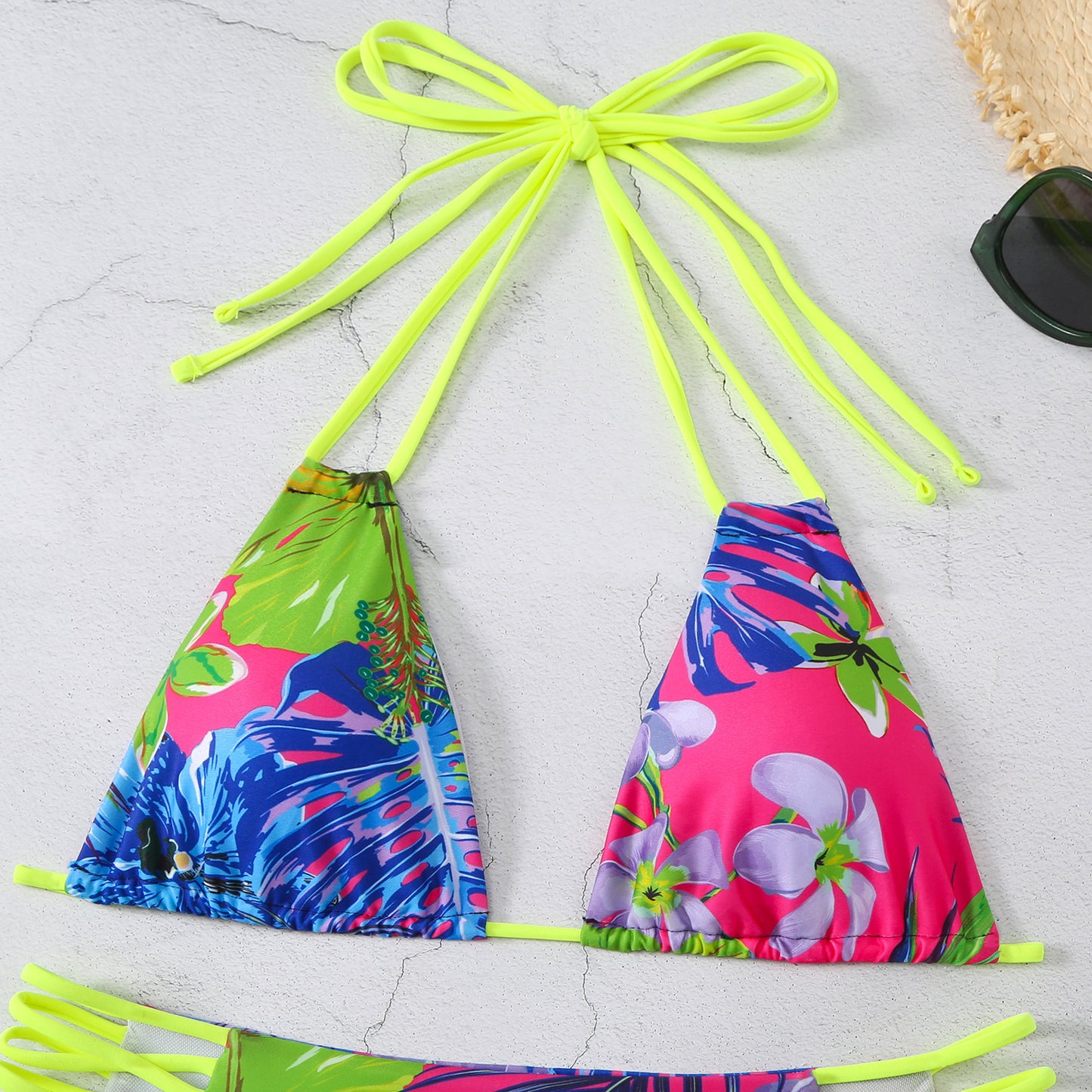 Colorful bikini set with floral design on a light gray background