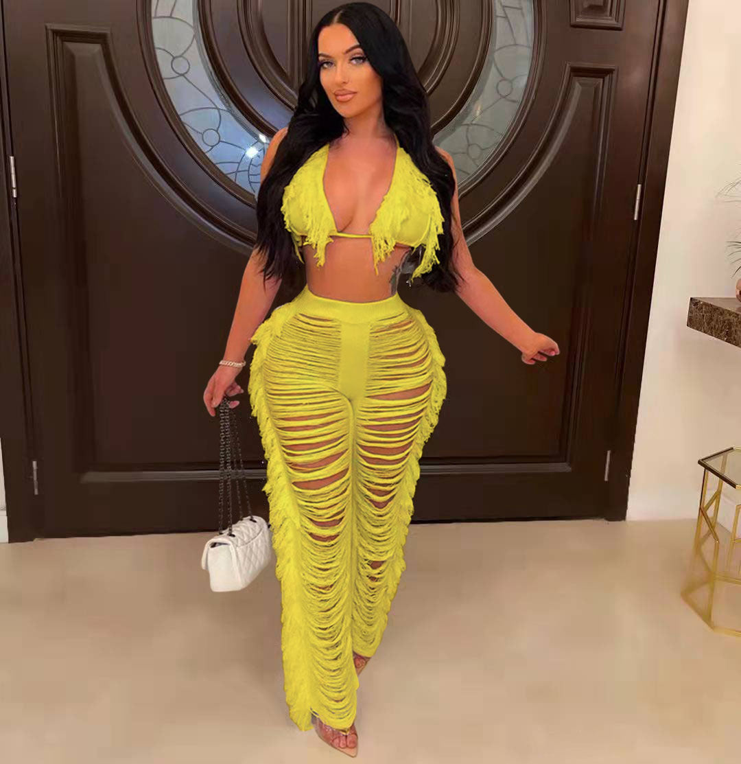 Woman in a bright yellow outfit standing in a room with a decorative door.