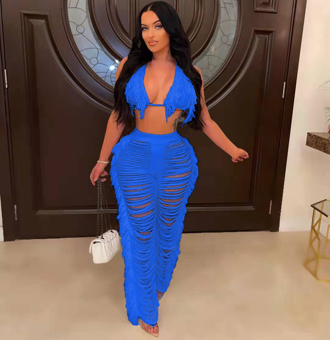 Woman in a blue outfit standing in a room with a decorative door.