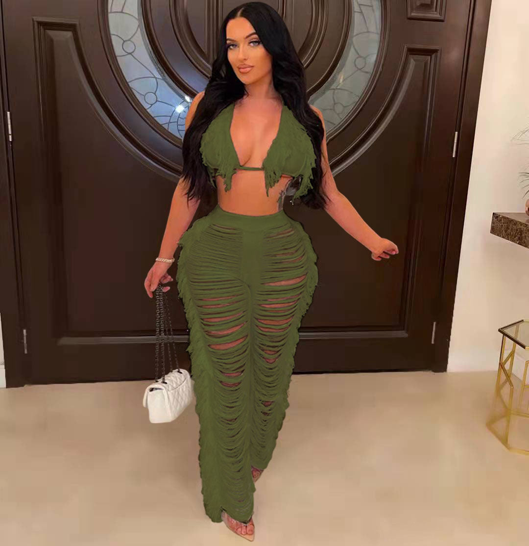 Woman in a green outfit standing in a room with a decorative door.
