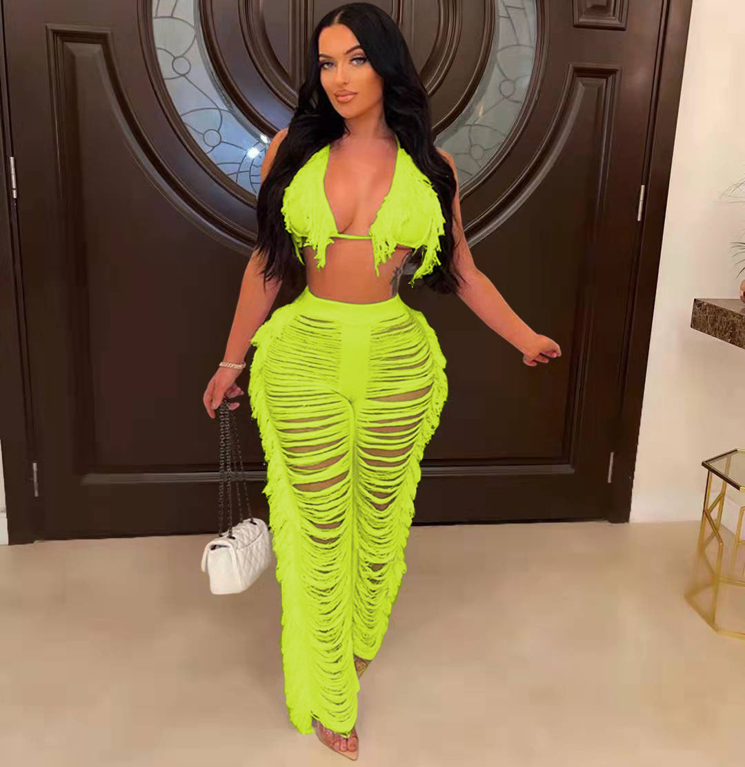 Woman wearing a bright green outfit with a textured design in an indoor setting.