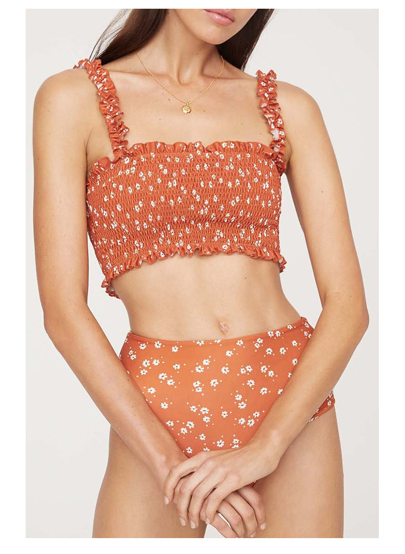 Woman wearing a floral bikini set on a white background