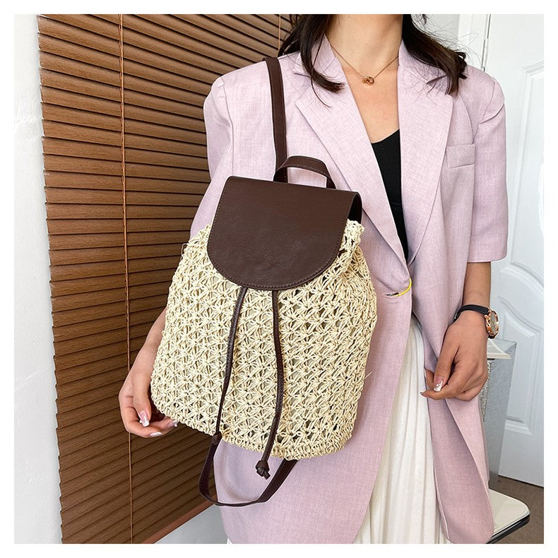 Person holding a brown leather and beige crochet backpack against a wooden panel background sold at PeachyBeanz