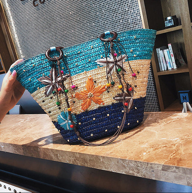 Colorful handbag with decorative elements on a marble surface