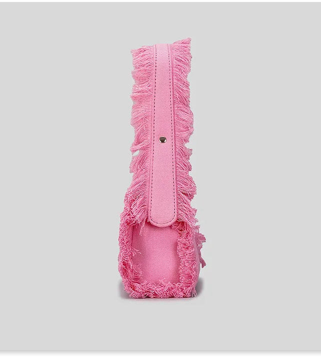 Pink headband with fringe details on a gray background