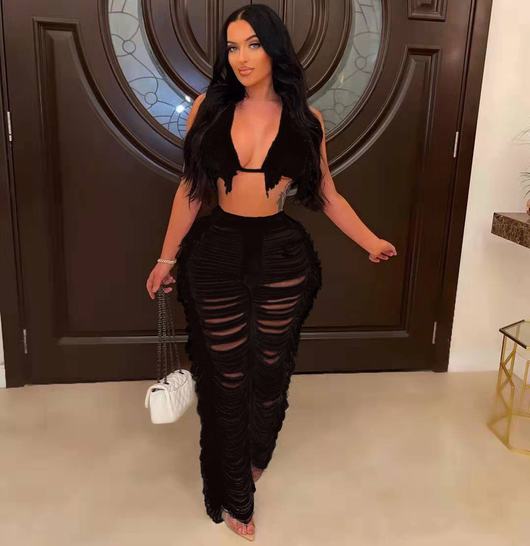 Woman in a black outfit standing in a room with a decorative door.