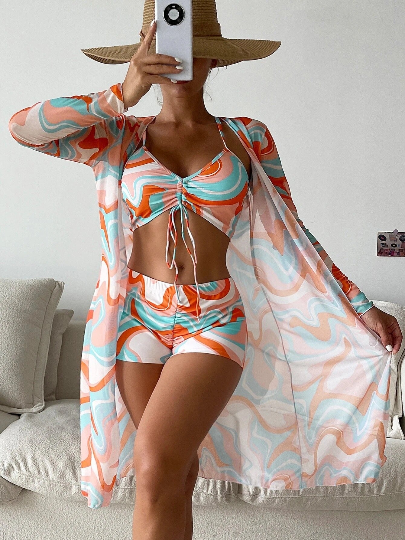 Three‑piece pattern print swimwear set featuring a supportive top, high‑waist bottoms, and coordinating cover or accessory piece; bold tropical foliage pattern and streamlined fit.
