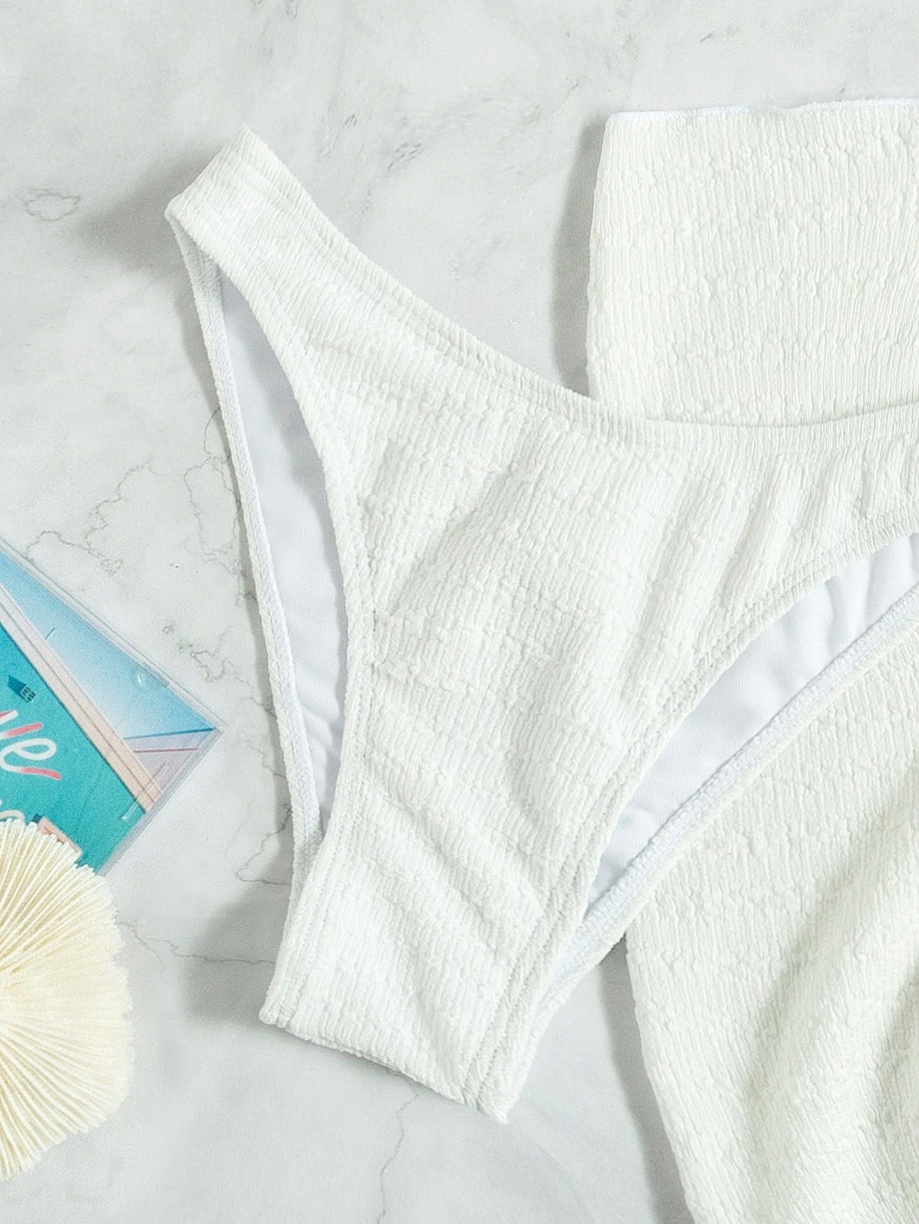White tube‑top bikini with flattering fit.