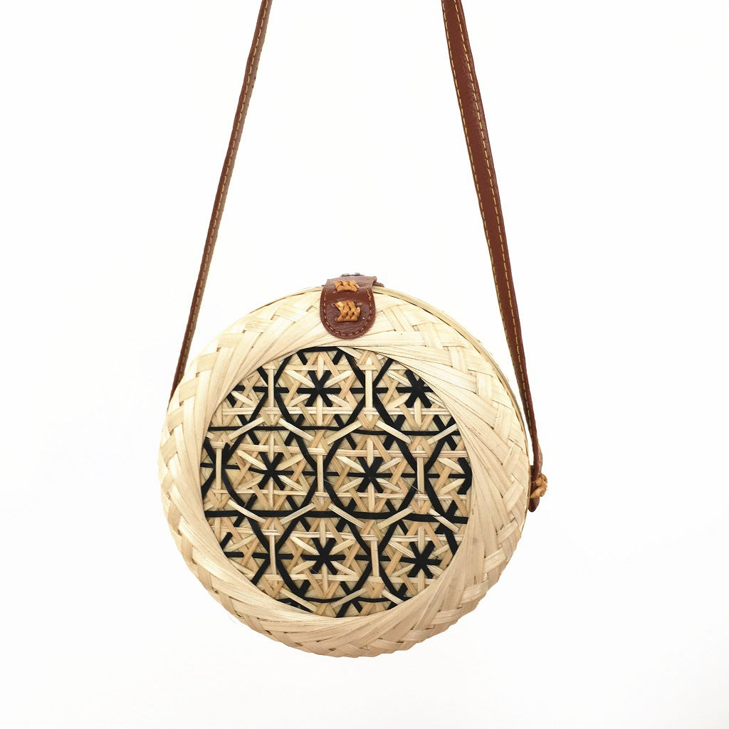 Woven basket with decorative lid on a white background