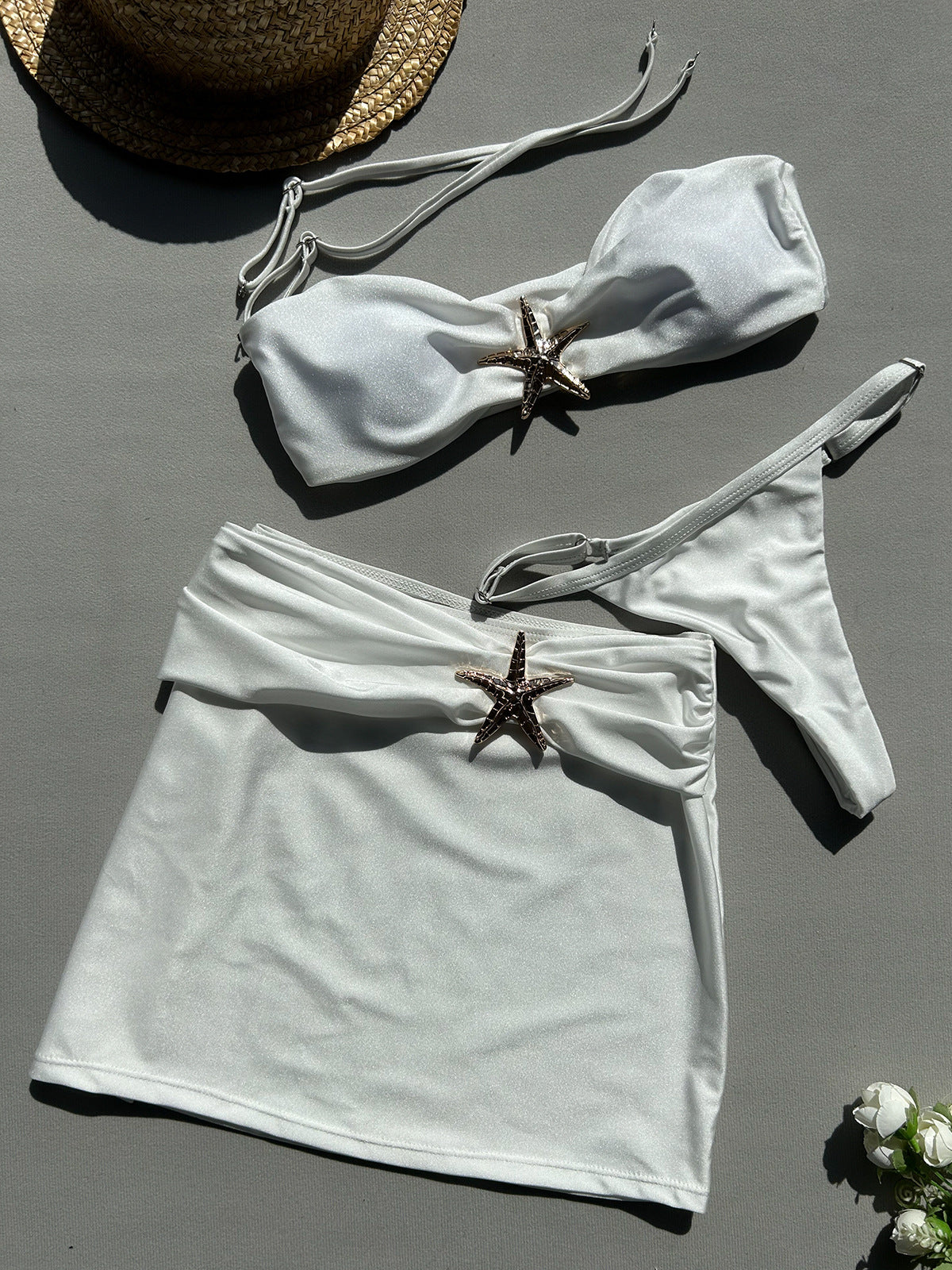 Bikini set with starfish decorations on a light gray 