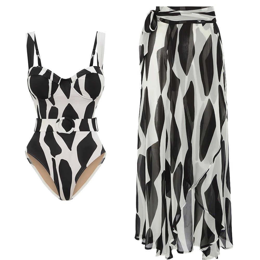 Flowing black and white swimsuit and skirt set designed as a matching cover‑up for the bikini set.
