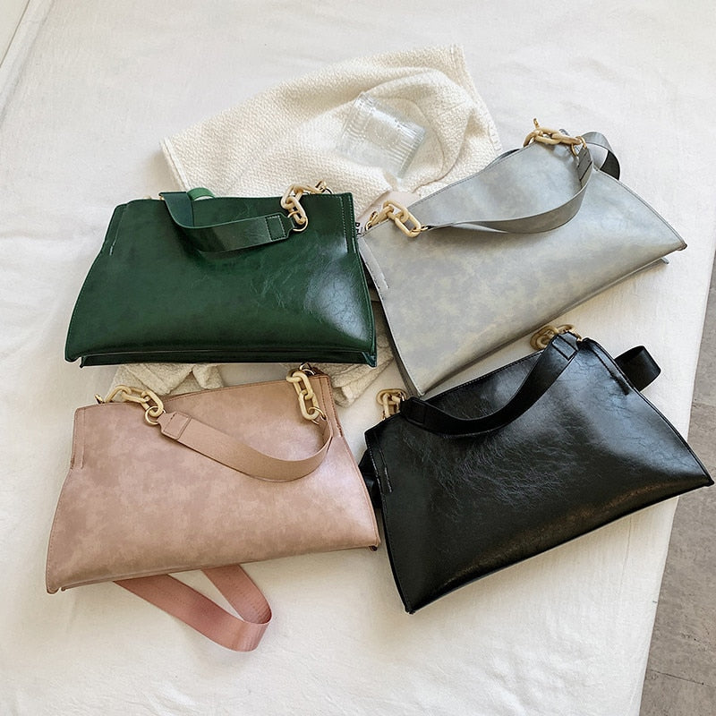 Large women's shoulder bag in soft faux leather, front view showing smooth finish and slim silhouette, black variant. Sold at PeachyBeanz.