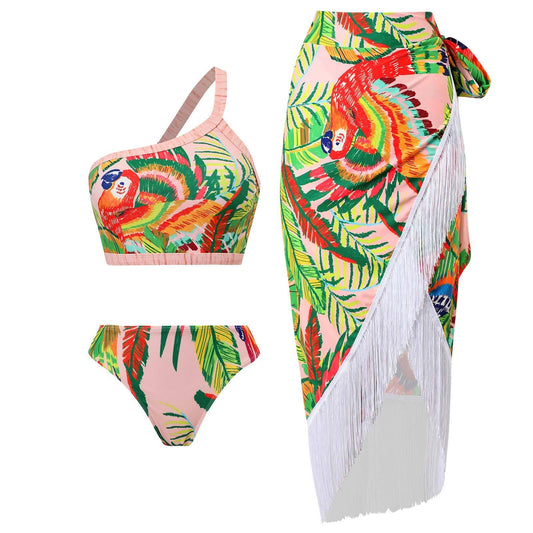 Tropical one‑shoulder bikini with wrap skirt; vibrant floral print, and adjustable strap.