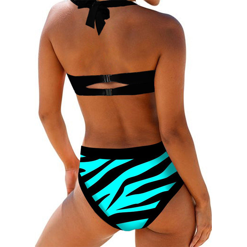 Woman wearing a striped 2-piece swimsuit against a white background.