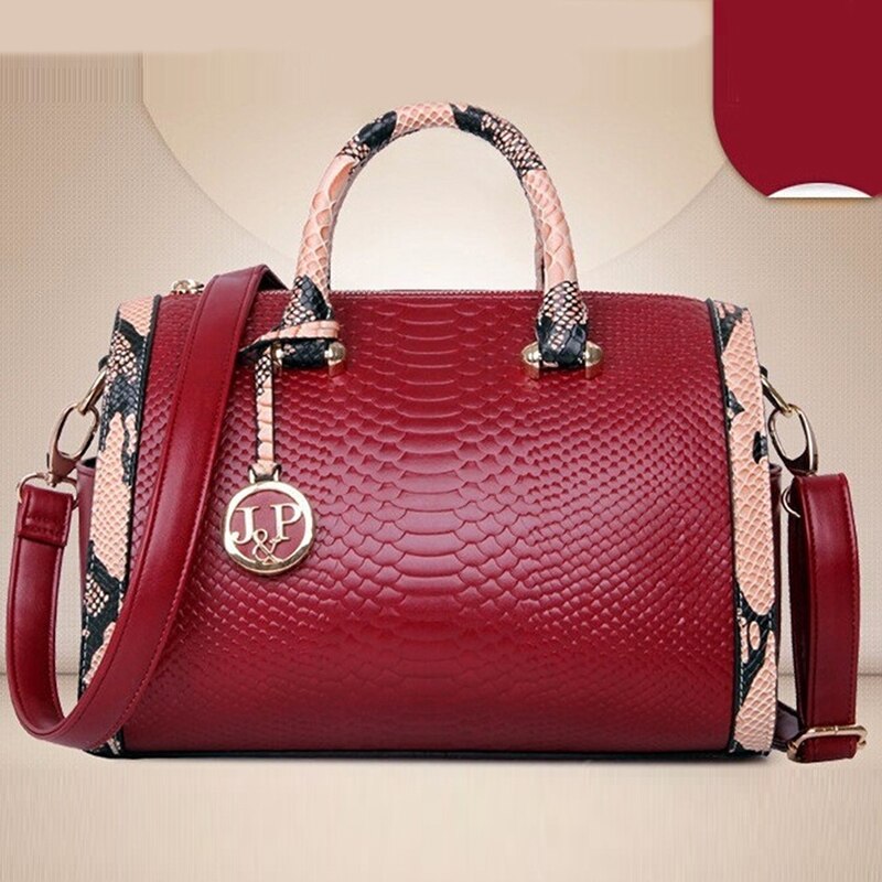 Women’s luxury faux‑leather snakeskin crossbody handbag with top handle and shoulder strap.