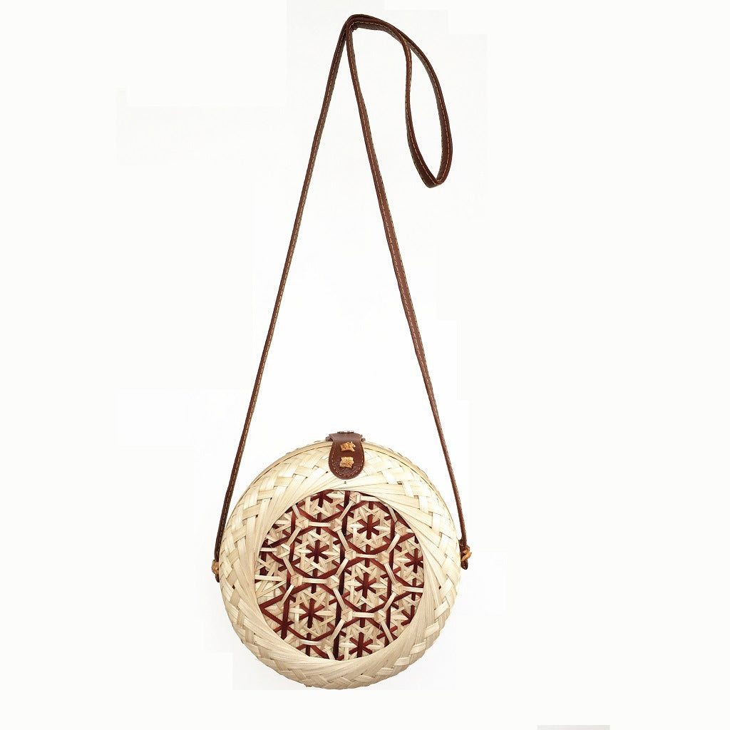 Woven basket with decorative lid on a white background