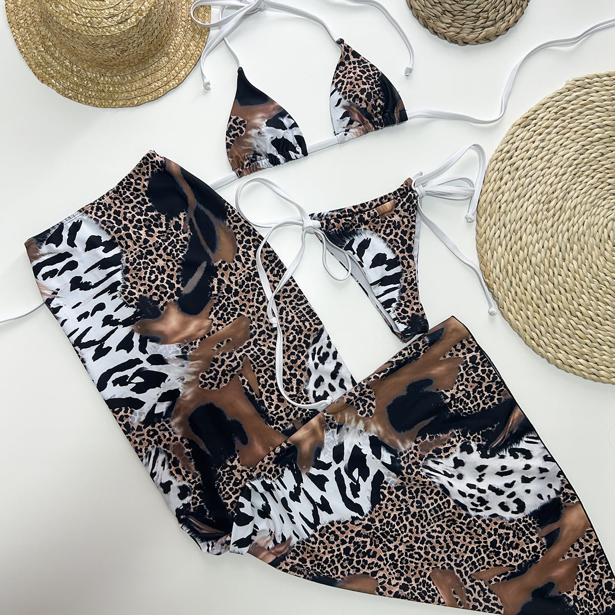 Female three‑piece leopard print bikini set featuring a padded, wire‑free nylon top with Lycra‑spandex lining, matching bottoms, and coordinating cover piece.
