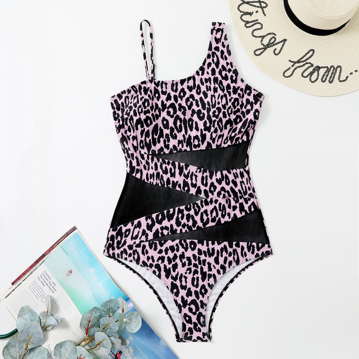 Animal print swimsuit with a tropical background sold at PeachyBeanz
