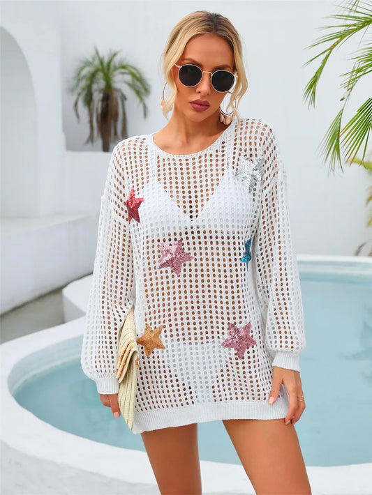 White semi‑sheer long‑sleeve mesh cover‑up with sequin star details, round neck, and slit and cutout accents.
