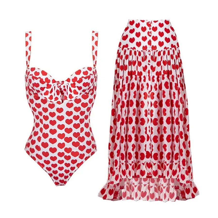 Retro printed one‑piece swimsuit with a matching flowing skirt cover‑up.