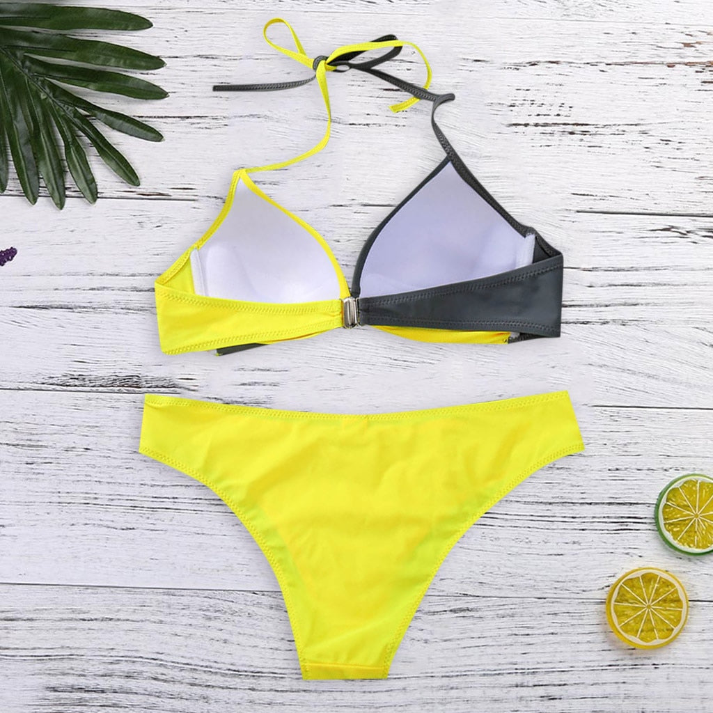 Two‑piece women’s bikini set featuring a padded push‑up top with spaghetti straps and a low‑waist patchwork bikini bottom, displayed in a flat lay on a neutral background.