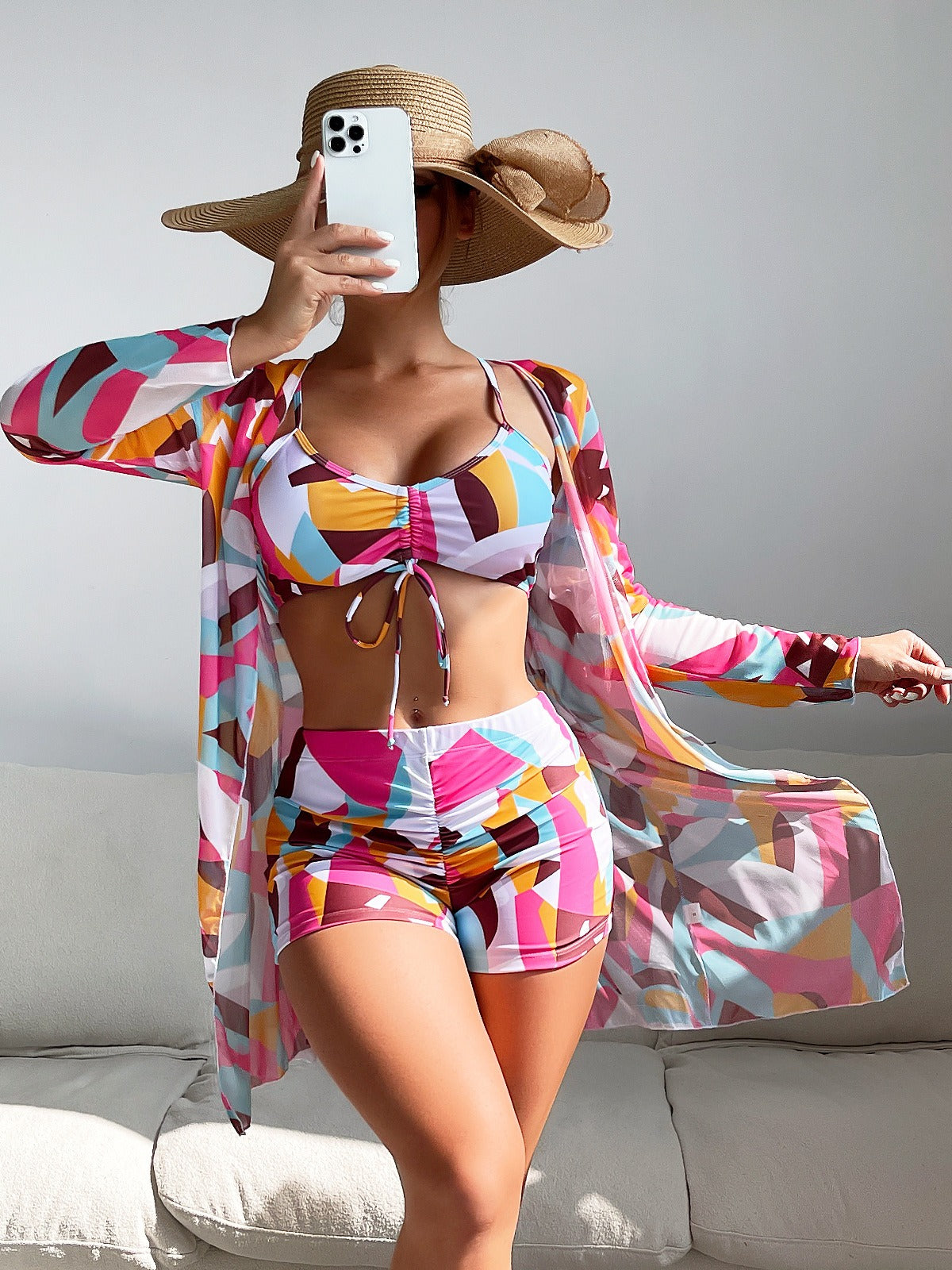 Three‑piece pattern print swimwear set featuring a supportive top, high‑waist bottoms, and coordinating cover or accessory piece; bold tropical foliage pattern and streamlined fit.