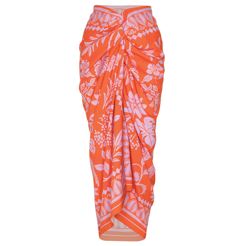 Orange swimsuit with floral details on a neutral background