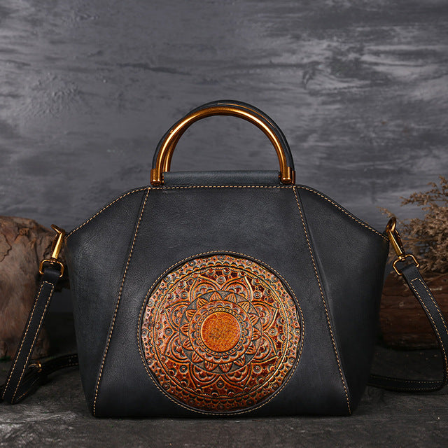Black genuine cow leather handbag with structured silhouette.