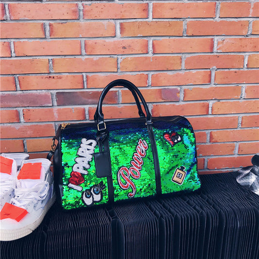 Green sequin clutch with 'I ❤️ Parks' text against a brick wall.