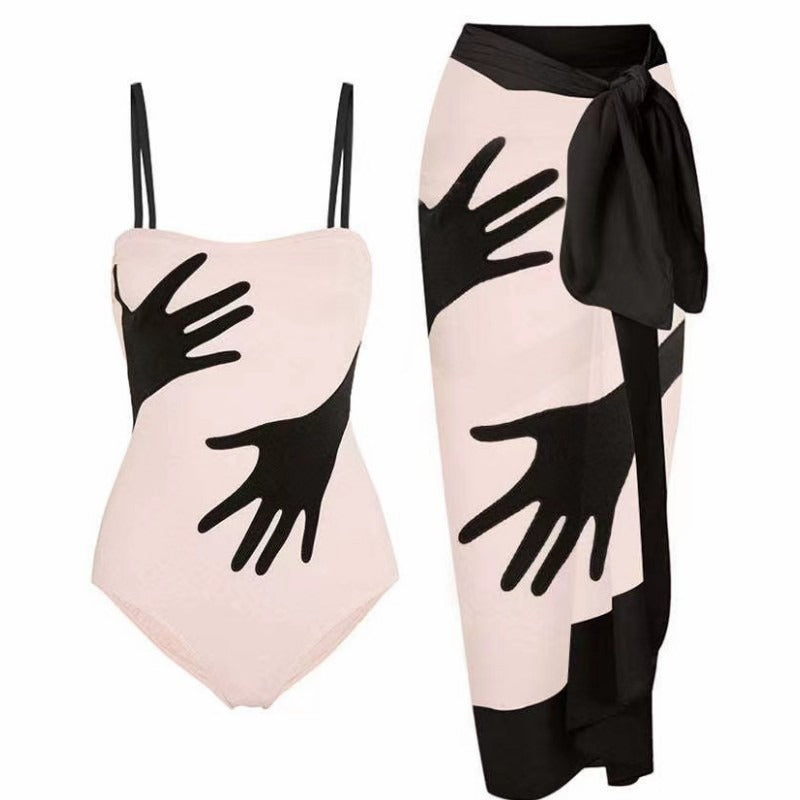 Black and white swimsuit and matching sarong sold at PeachyBeanz.