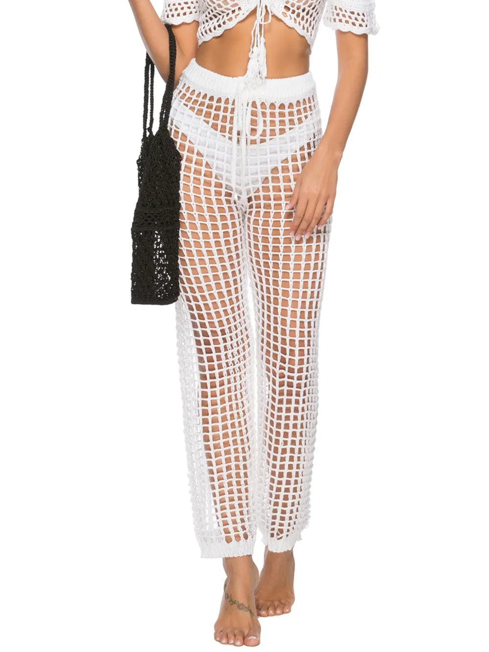 High‑waist cutout swim cover‑up pants with tie‑up closure in a solid color, displayed on a plain background.