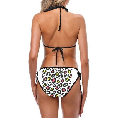 Woman wearing an animal print swimsuit against a white background.