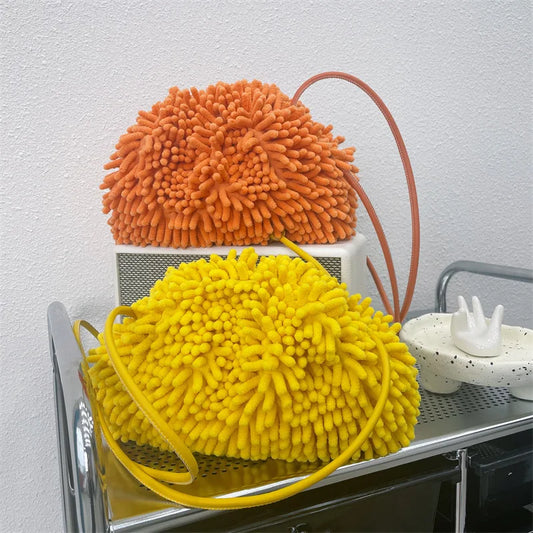 Pouch bags textured handbag against a white wall sold at PeachyBeanz.