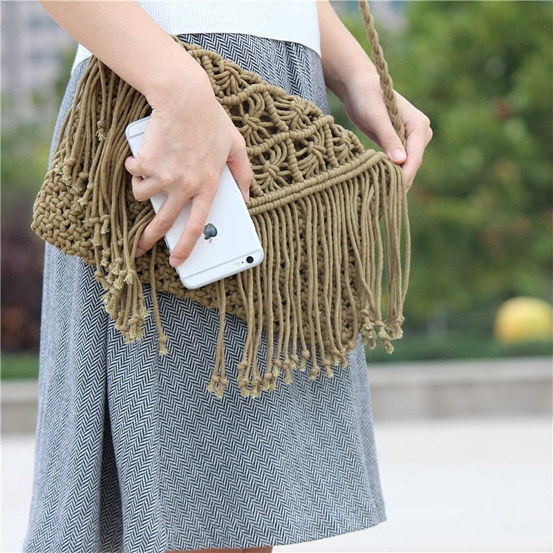 Person wearing a gray skirt with a woven bag on a white background