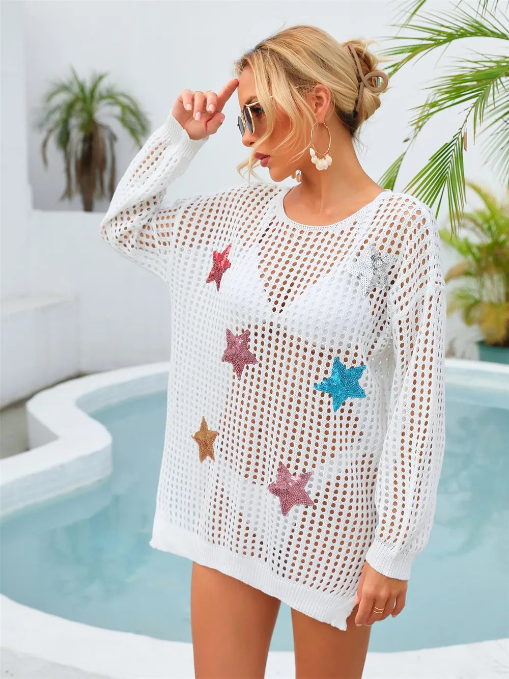 White semi‑sheer long‑sleeve mesh cover‑up with sequin star details, round neck, and slit and cutout accents.