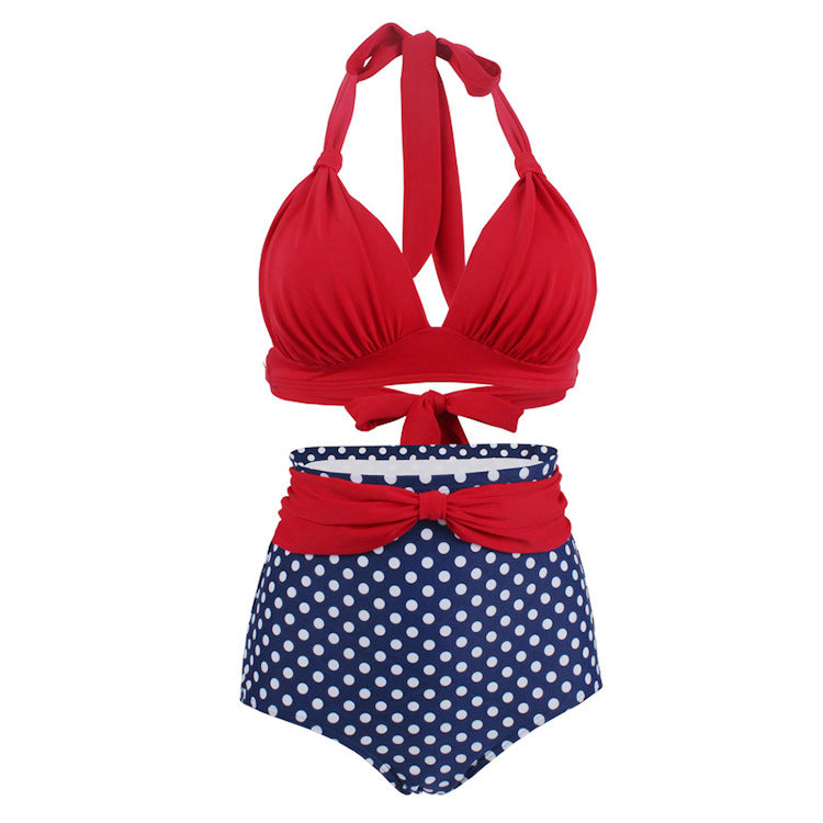 Woman wearing a red halter bikini top and high‑waisted blue with white polka dot bottoms.