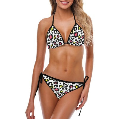 Woman wearing an animal print swimsuit against a white background.