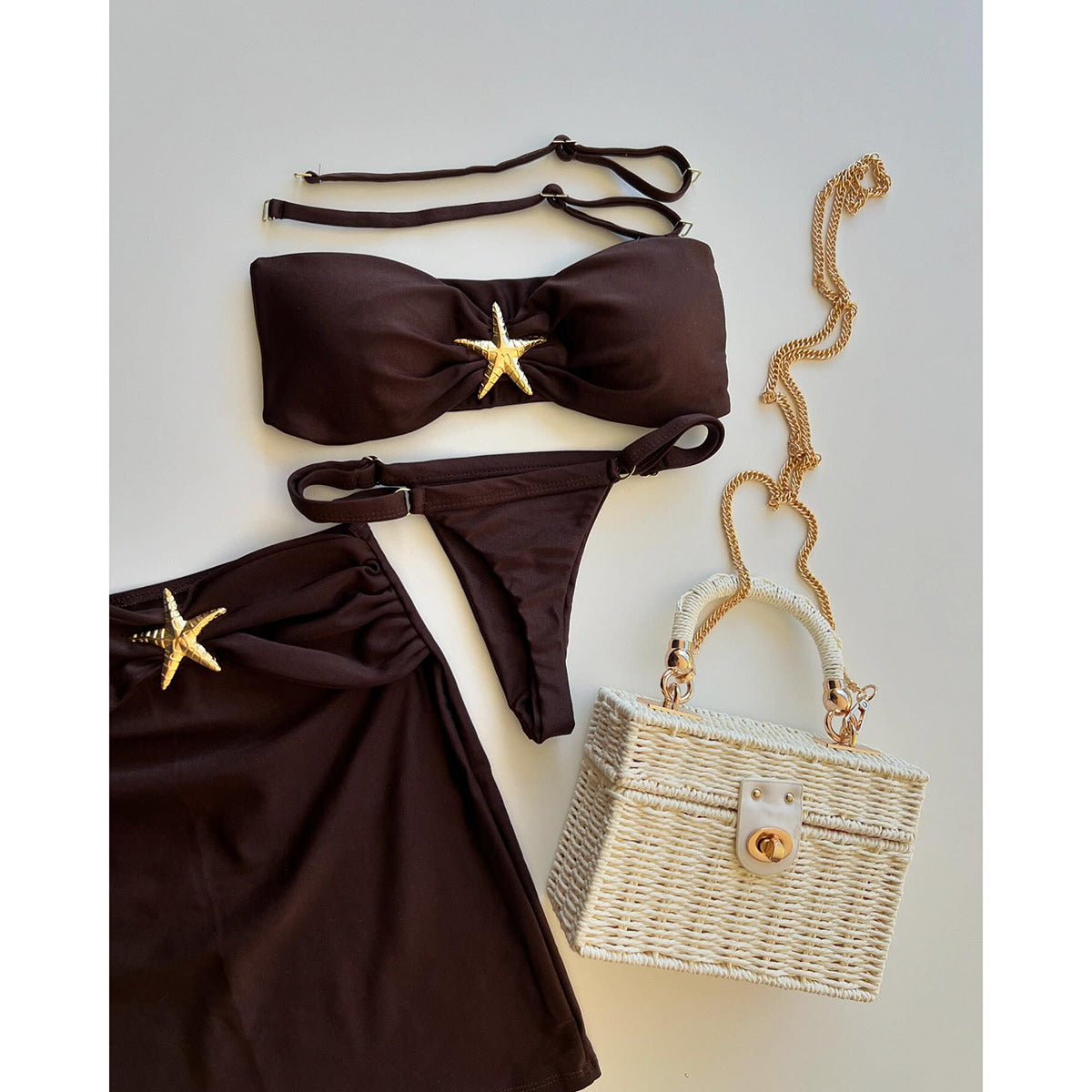 Brown bikini set with starfish decorations on a light gray 